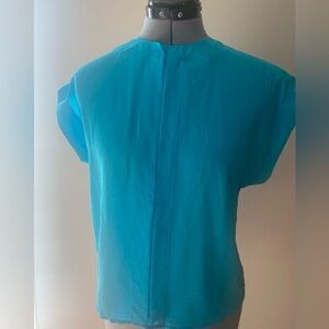 Beautiful turquoise blouse with stitching around neck, down front and sleeves